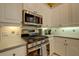 Well-equipped kitchen with stainless steel appliances, tile backsplash, and ample counter space at 7762 Us Open Loop, Lakewood Ranch, FL 34202