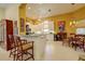 Open kitchen featuring white cabinets, tile floors, large island with bar seating, and pendant lighting at 7762 Us Open Loop, Lakewood Ranch, FL 34202