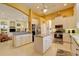 Spacious kitchen featuring white cabinetry and a large island with pendant lighting at 7762 Us Open Loop, Lakewood Ranch, FL 34202