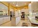Well-lit kitchen with white cabinets, stainless appliances, and a functional island at 7762 Us Open Loop, Lakewood Ranch, FL 34202