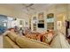 Comfortable living room featuring built-in shelving and direct access to the lanai at 7762 Us Open Loop, Lakewood Ranch, FL 34202