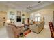 Bright living room featuring built-in shelving, tile floors, and comfortable seating arrangement at 7762 Us Open Loop, Lakewood Ranch, FL 34202