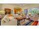 Inviting living room featuring plush seating, bright natural light, and a decorative rug at 7762 Us Open Loop, Lakewood Ranch, FL 34202