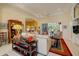 Inviting living room with tray ceilings, comfortable seating, and an open layout to adjacent rooms at 7762 Us Open Loop, Lakewood Ranch, FL 34202