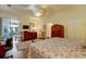 Cozy main bedroom with wood floors, ceiling fan, and sliding glass doors leading to the outdoor living space at 7762 Us Open Loop, Lakewood Ranch, FL 34202