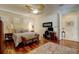 Spacious main bedroom with hardwood floors, ceiling fan, and ensuite bathroom access at 7762 Us Open Loop, Lakewood Ranch, FL 34202