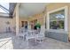 Covered patio with seating area perfect for relaxing or entertaining with views of the house at 7762 Us Open Loop, Lakewood Ranch, FL 34202