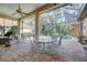 Open-air patio with a screened-in pool, seating for outdoor dining, and lush plants at 7762 Us Open Loop, Lakewood Ranch, FL 34202