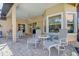 Covered outdoor patio with tiled floors, ceiling fan, and seating area at 7762 Us Open Loop, Lakewood Ranch, FL 34202