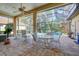 Relaxing screened-in lanai area with multiple seating areas that surround the in ground swimming pool at 7762 Us Open Loop, Lakewood Ranch, FL 34202