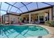 Sparkling in-ground pool surrounded by a patio and lanai with seating and views of the home at 7762 Us Open Loop, Lakewood Ranch, FL 34202
