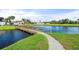 Scenic view of a wooden bridge crossing a serene waterway with lush landscaping at 808 Capri Isles Blvd # 216, Venice, FL 34292