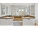 Bathroom featuring double vanity sinks with granite countertops, white cabinets, and a large mirror at 8122 Spring Marsh Dr, University Park, FL 34201