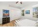 Cozy bedroom featuring a black and white palette, hardwood floors, and two windows for natural light at 8122 Spring Marsh Dr, University Park, FL 34201