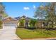 Charming one-story home with manicured lawn, mature trees, and a two-car garage at 8122 Spring Marsh Dr, University Park, FL 34201