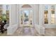 Elegant foyer with tile flooring, decorative columns, and a bright front door providing natural light at 8122 Spring Marsh Dr, University Park, FL 34201