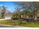 Well-maintained front yard of a one-story home with a two-car garage and mature landscaping at 8122 Spring Marsh Dr, University Park, FL 34201
