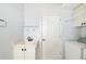 Bright laundry room with a sink, storage cabinets, and a modern washing machine at 8122 Spring Marsh Dr, University Park, FL 34201