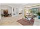 Open-concept living area with tile floors, neutral paint, and seamless flow into adjacent dining and outdoor spaces at 8122 Spring Marsh Dr, University Park, FL 34201