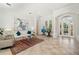 Open-concept living area featuring tile floors and abundant natural light from the front entry at 8122 Spring Marsh Dr, University Park, FL 34201