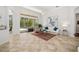 Bright living room overlooking the pool area through sliding glass doors, with tile flooring at 8122 Spring Marsh Dr, University Park, FL 34201