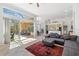 Expansive living area boasting tile flooring, neutral decor, and seamless access to an outdoor screened-in patio at 8122 Spring Marsh Dr, University Park, FL 34201
