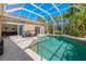 Enclosed pool area with screen enclosure, outdoor seating, and lush landscaping providing privacy at 8122 Spring Marsh Dr, University Park, FL 34201