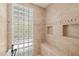 Modern bathroom with a glass block window accenting the walk-in shower, providing natural light at 8122 Spring Marsh Dr, University Park, FL 34201
