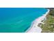 Stunning aerial of a beautiful beach with clear turquoise water and sunbathers at 8735 Midnight Pass Rd # 105B, Sarasota, FL 34242