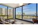 Enclosed balcony featuring comfortable seating and a panoramic view of the water and landscape at 8735 Midnight Pass Rd # 105B, Sarasota, FL 34242