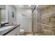 Bathroom with a glass shower stall, vanity with countertop, and aquatic wall decor at 8735 Midnight Pass Rd # 105B, Sarasota, FL 34242