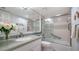Bathroom featuring a granite countertop, large mirror, bathtub/shower combo, and decorative accents at 8735 Midnight Pass Rd # 105B, Sarasota, FL 34242