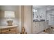 A decorative bathroom features a vanity, an accent mirror, and bead strings in lieu of a door at 8735 Midnight Pass Rd # 105B, Sarasota, FL 34242