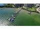 Scenic aerial shot of a boat dock with multiple slips and several boats moored at 8735 Midnight Pass Rd # 105B, Sarasota, FL 34242