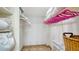 Walk in closet with ample shelving and storage space plus decorative wicker basket at 8735 Midnight Pass Rd # 105B, Sarasota, FL 34242