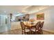 Dining area near the kitchen with an elegant chandelier and stylish wood floors at 8735 Midnight Pass Rd # 105B, Sarasota, FL 34242