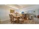 Bright dining room featuring a chandelier and stylish wood floors at 8735 Midnight Pass Rd # 105B, Sarasota, FL 34242