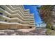 Beautiful condo building featuring multiple balconies, garages, and brick paver parking area at 8735 Midnight Pass Rd # 105B, Sarasota, FL 34242