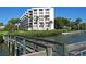 Exterior view of a modern building complex with well-maintained waterfront and docks at 8735 Midnight Pass Rd # 105B, Sarasota, FL 34242