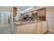 Updated kitchen with granite countertops, mosaic backsplash, stainless steel appliances, and wood cabinets at 8735 Midnight Pass Rd # 105B, Sarasota, FL 34242