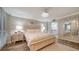 Bright bedroom with a luxurious bed, stylish decor, and a glimpse into the ensuite bathroom at 8735 Midnight Pass Rd # 105B, Sarasota, FL 34242
