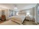 Serene bedroom with a chandelier, wood-look flooring, and a view to the outside balcony at 8735 Midnight Pass Rd # 105B, Sarasota, FL 34242