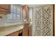 Office nook with a granite countertop desk, shuttered window, wicker chair, and decorative details at 8735 Midnight Pass Rd # 105B, Sarasota, FL 34242