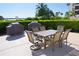 Outdoor patio space with dining table and chairs is perfect for outdoor meals and overlooking community activities at 8735 Midnight Pass Rd # 105B, Sarasota, FL 34242