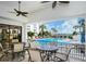 View of the pool with dining area, lounge chairs, and ample space for relaxation and entertainment by the water at 8735 Midnight Pass Rd # 105B, Sarasota, FL 34242