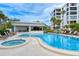 Relax by the community pool with a hot tub and pool house, an ideal spot for community gatherings and leisure activities at 8735 Midnight Pass Rd # 105B, Sarasota, FL 34242