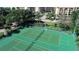 Aerial view of immaculately maintained tennis courts surrounded by lush landscaping at 8735 Midnight Pass Rd # 105B, Sarasota, FL 34242