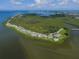 Scenic aerial view showcases waterfront condos, a pool, and surrounding natural beauty, offering tranquil living at 92 Tidy Island Blvd, Bradenton, FL 34210