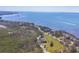 Breathtaking aerial view of the waterfront property featuring manicured grounds and mature trees at 92 Tidy Island Blvd, Bradenton, FL 34210