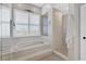 Bright bathroom featuring a soaking tub, glass shower, and plantation shutters for privacy at 92 Tidy Island Blvd, Bradenton, FL 34210
